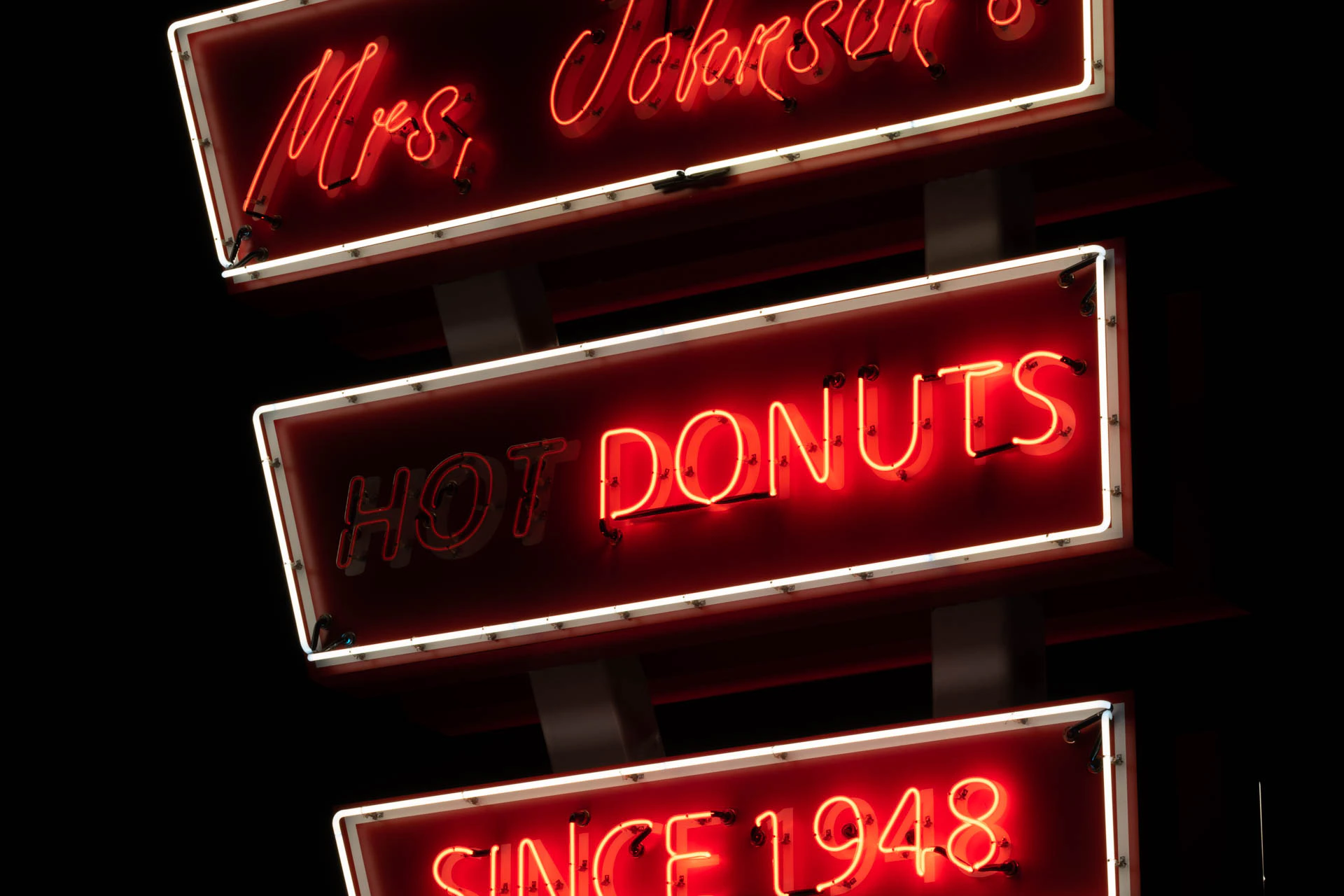 mrs Johnsons hot donuts neon sign in Austin Texas at night