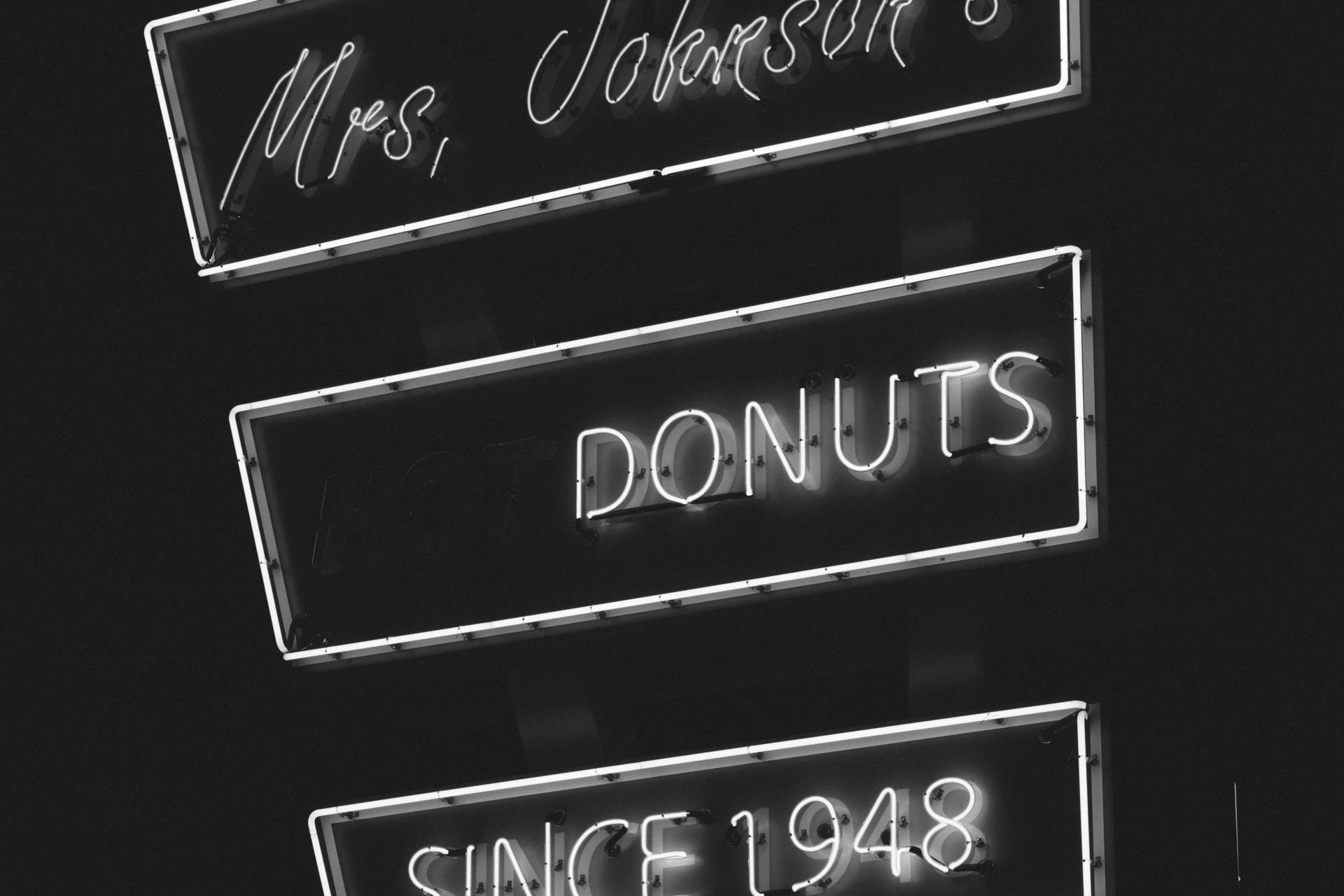 mrs Johnsons hot donuts neon sign in Austin Texas at night