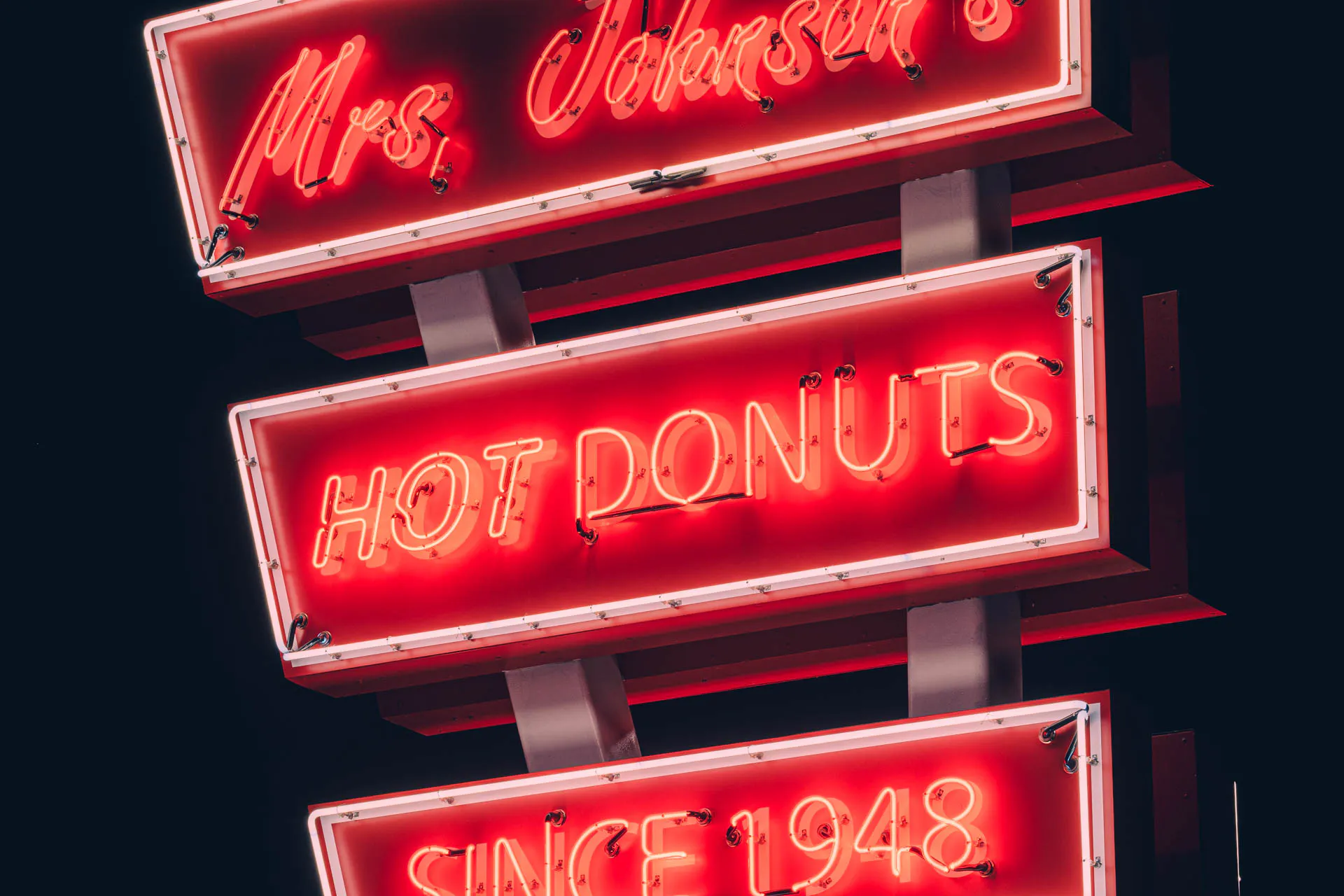 close up of mrs Johnsons hot donuts red neon sign in Austin Texas at night