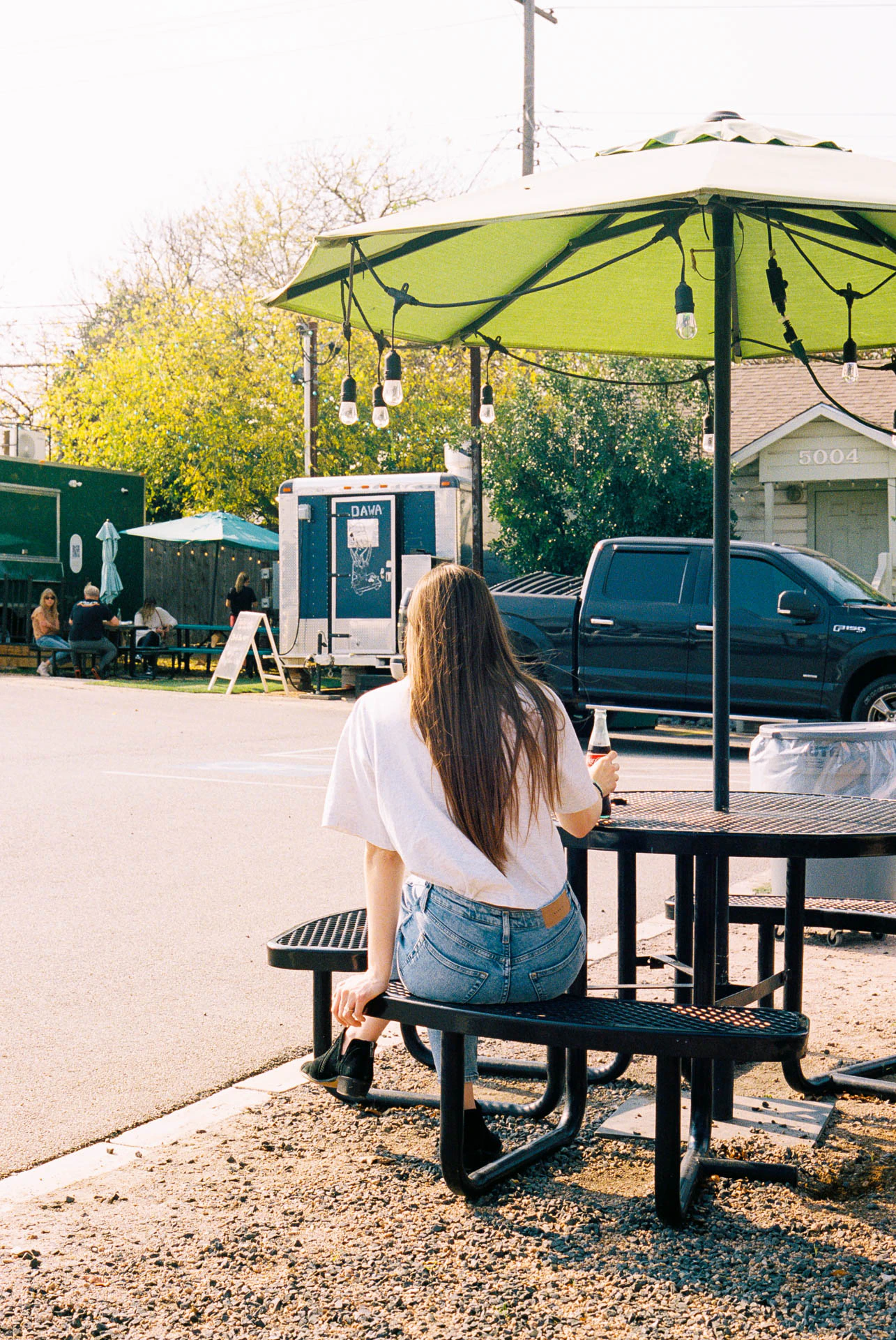 woman drinking a coke in Austin, texas on film