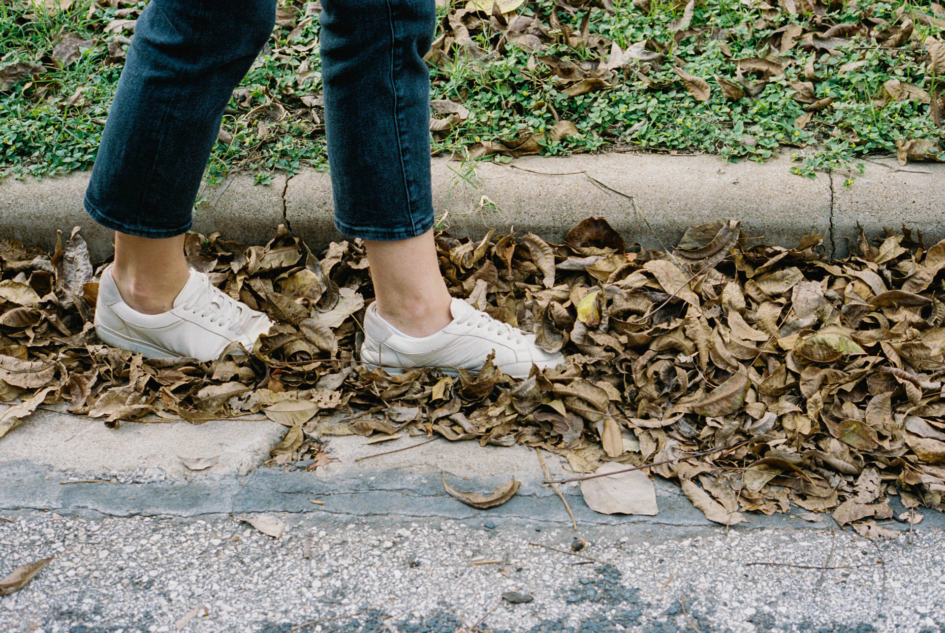 woman walking in leaves on film