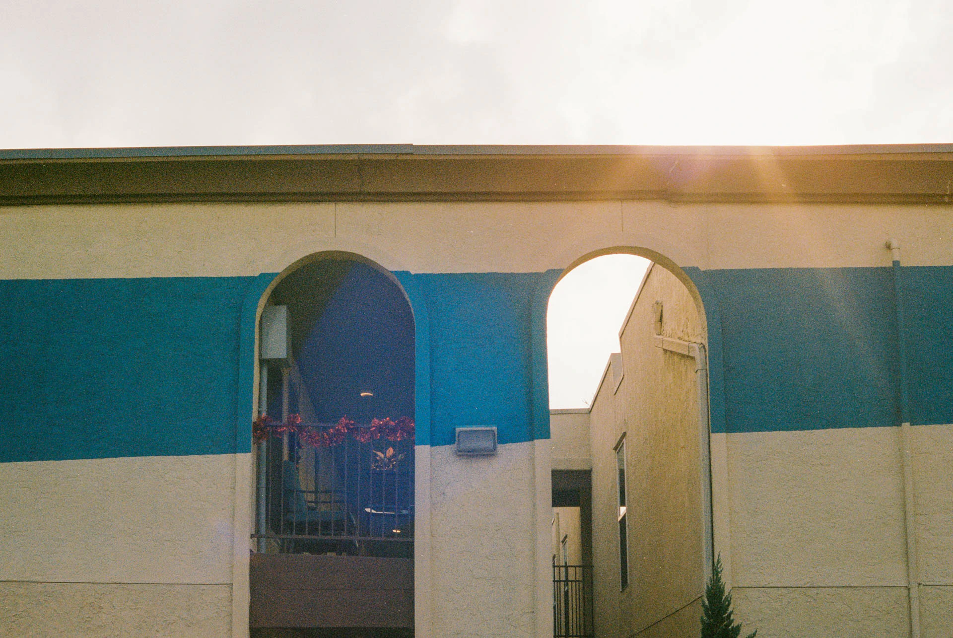 arched starburst entryway of apartment building on film