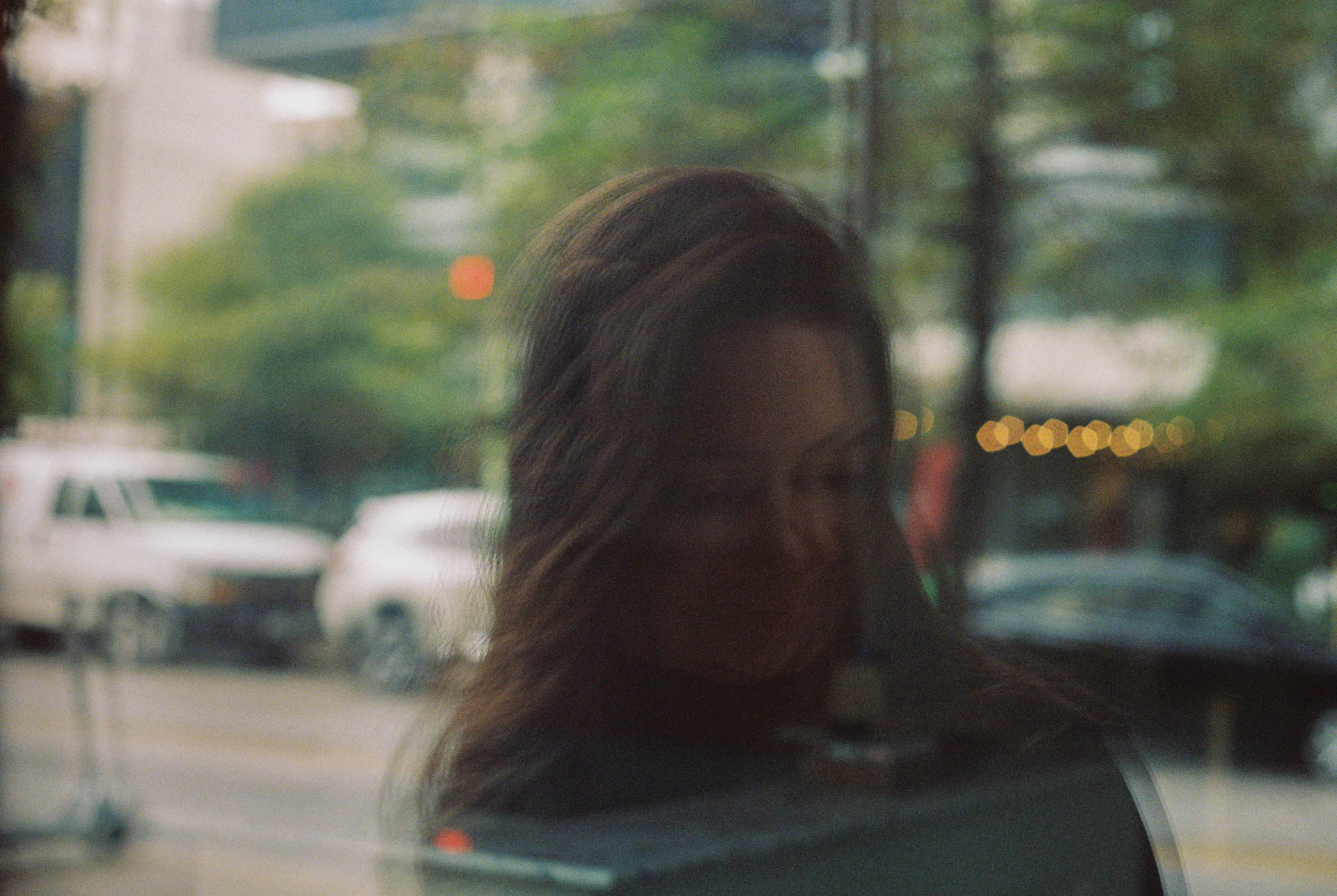 woman in a window reflection in Downtown Austin on film