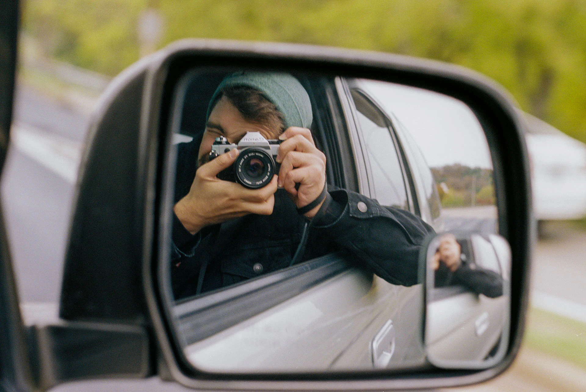 selfie of Jonathan Grado with canon ae 1 on film