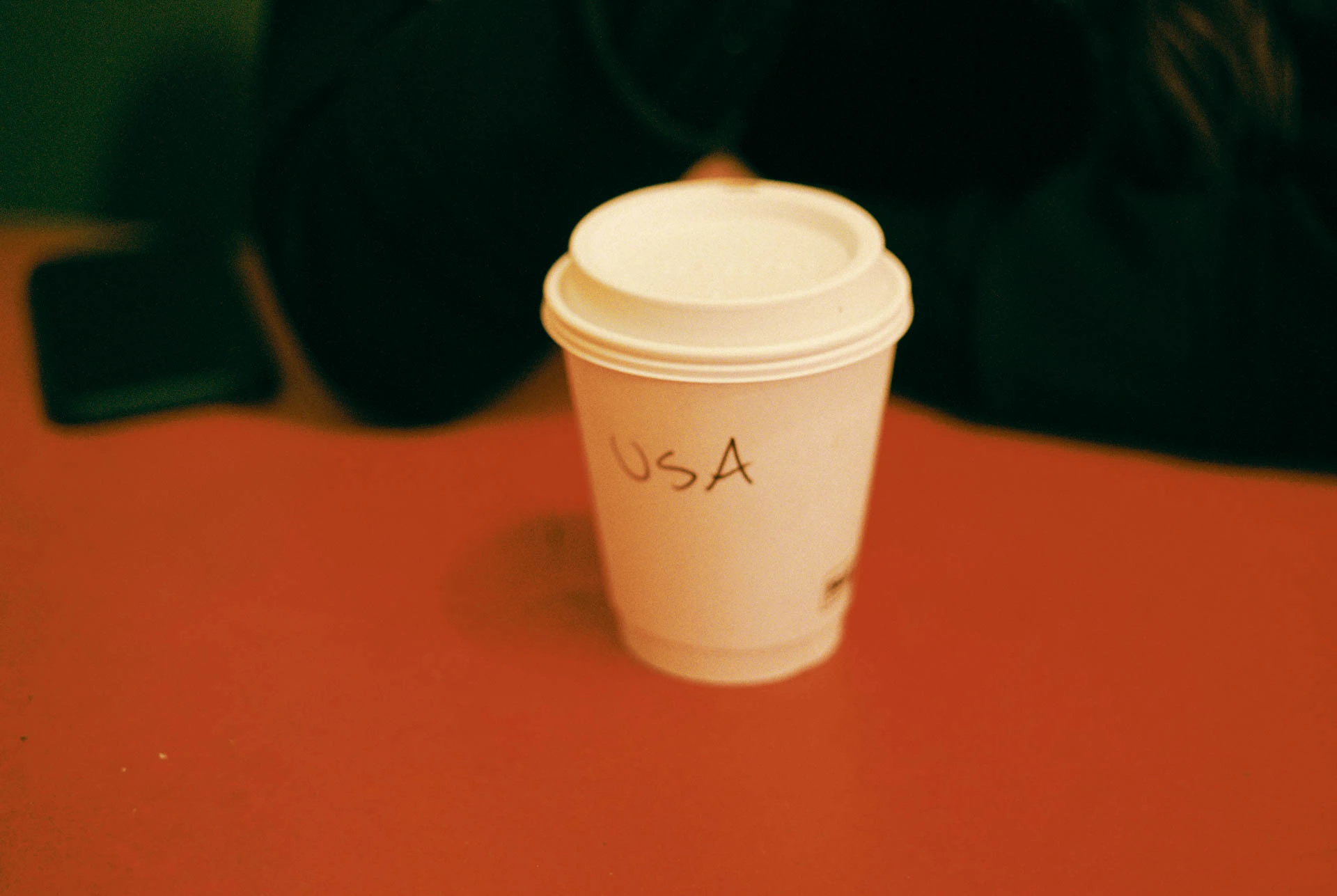 joe's coffee cup reading USA in Austin on film