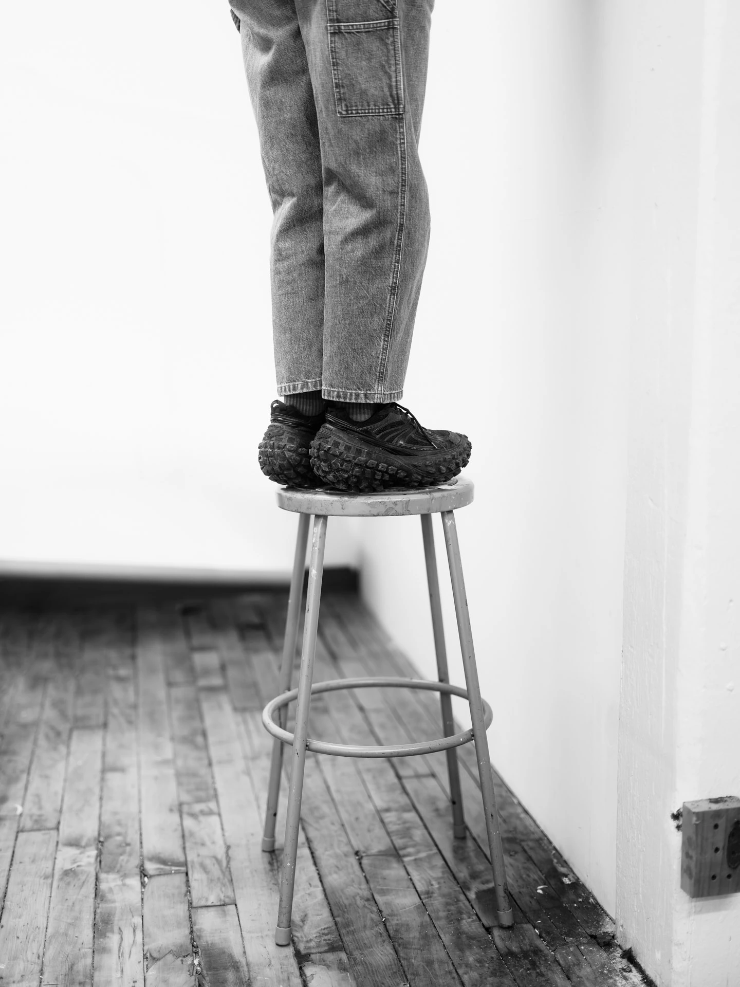 standing on a stool in black and white in Lara Saget studio