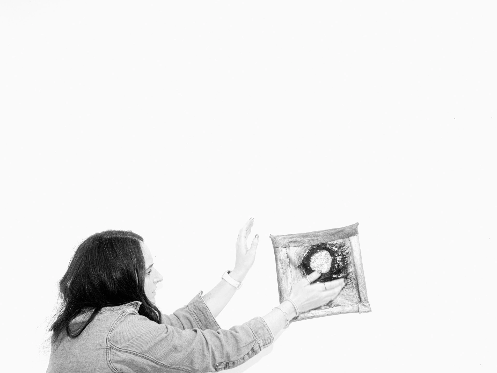 Lara Saget with artwork in black and white