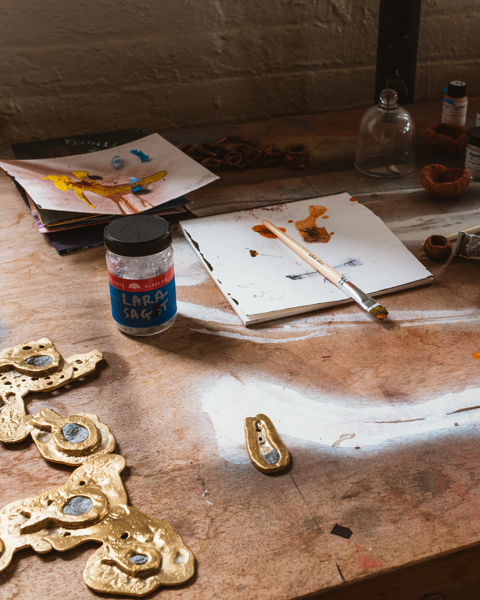 jar reading Lara Saget on desk in studio