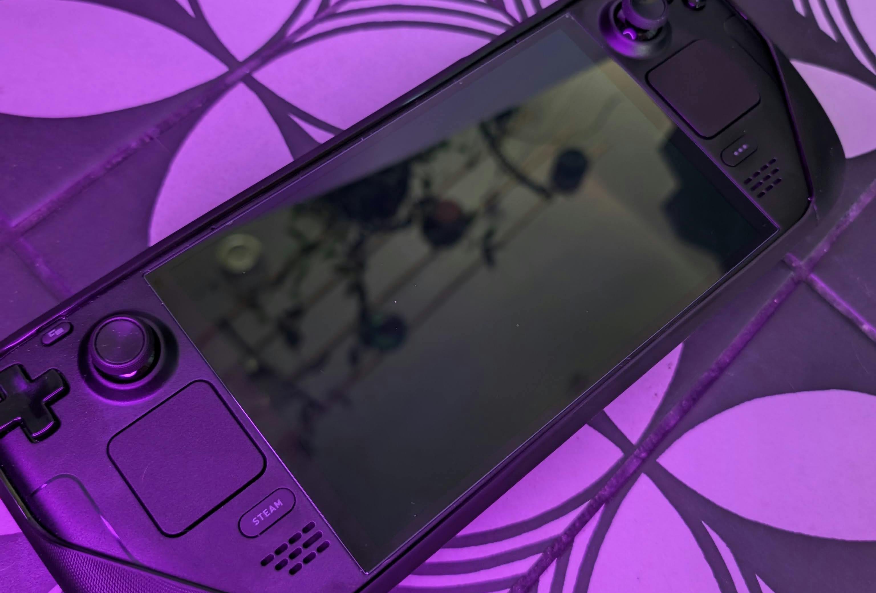 Steam Deck, lit with purple light for maximum atmosphere.