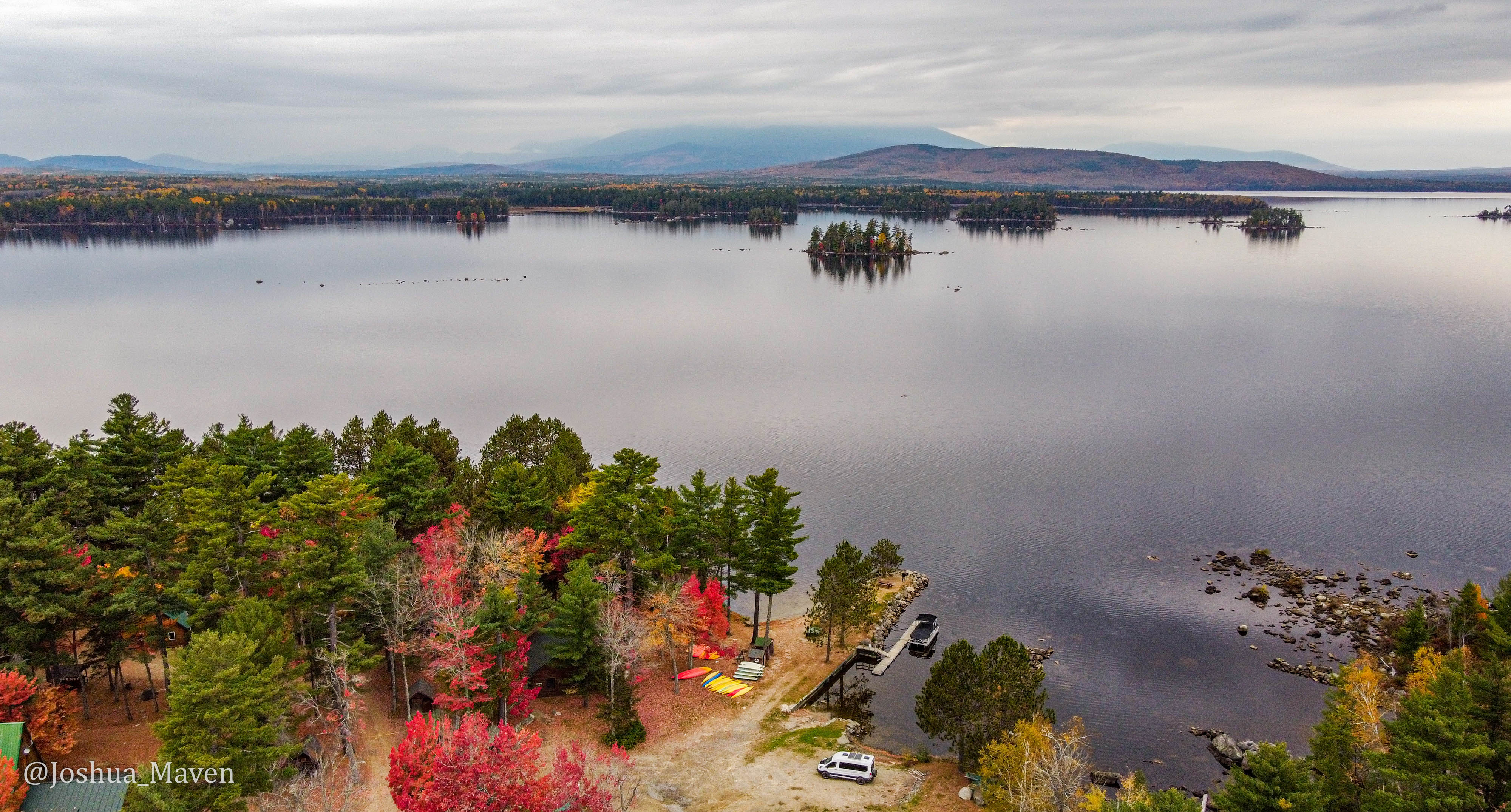 I took this drone shot from the shore of Millinocket Lake with Mount Katahdin shrouded behind clouds in the distance.