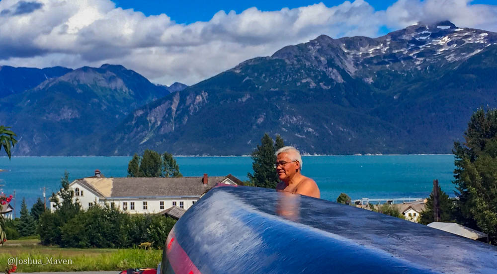 Here is Wayne working on a dugout canoe he carved from a single piece of wood. Portage Cove can be seen in the background.