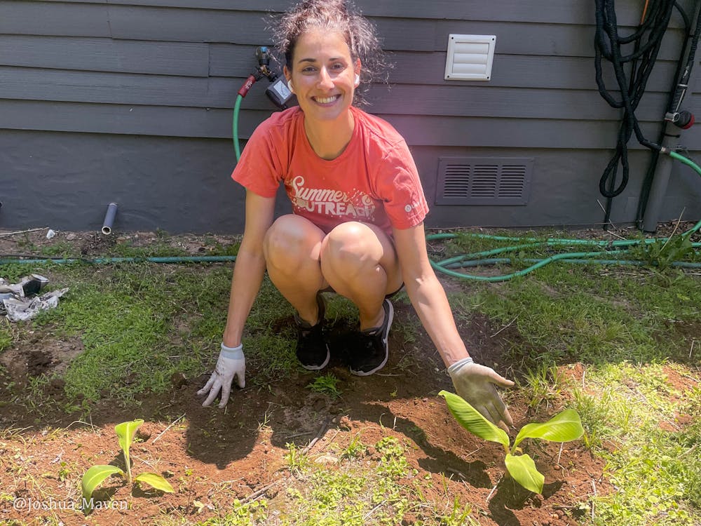This is my wife Celine after planting the two banana plants, Gene and Mary, in our backyard.