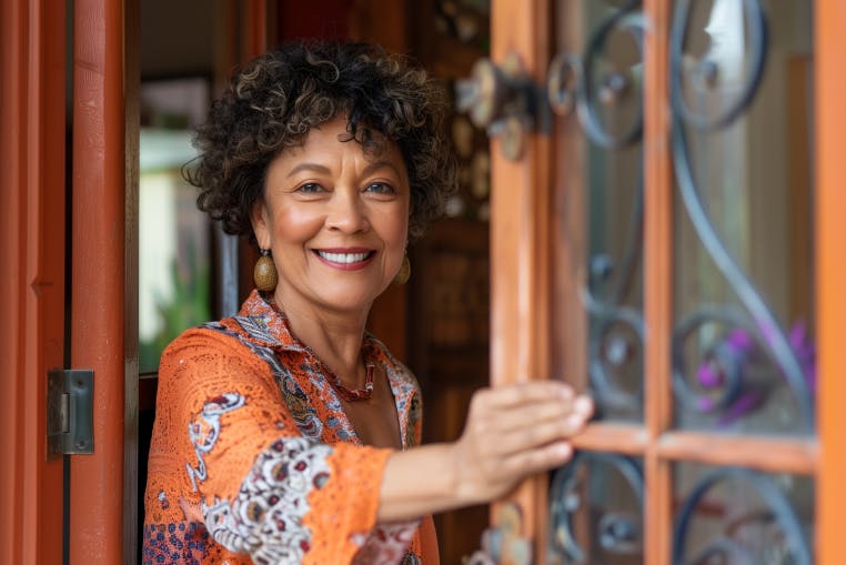 Mature woman by her home door
