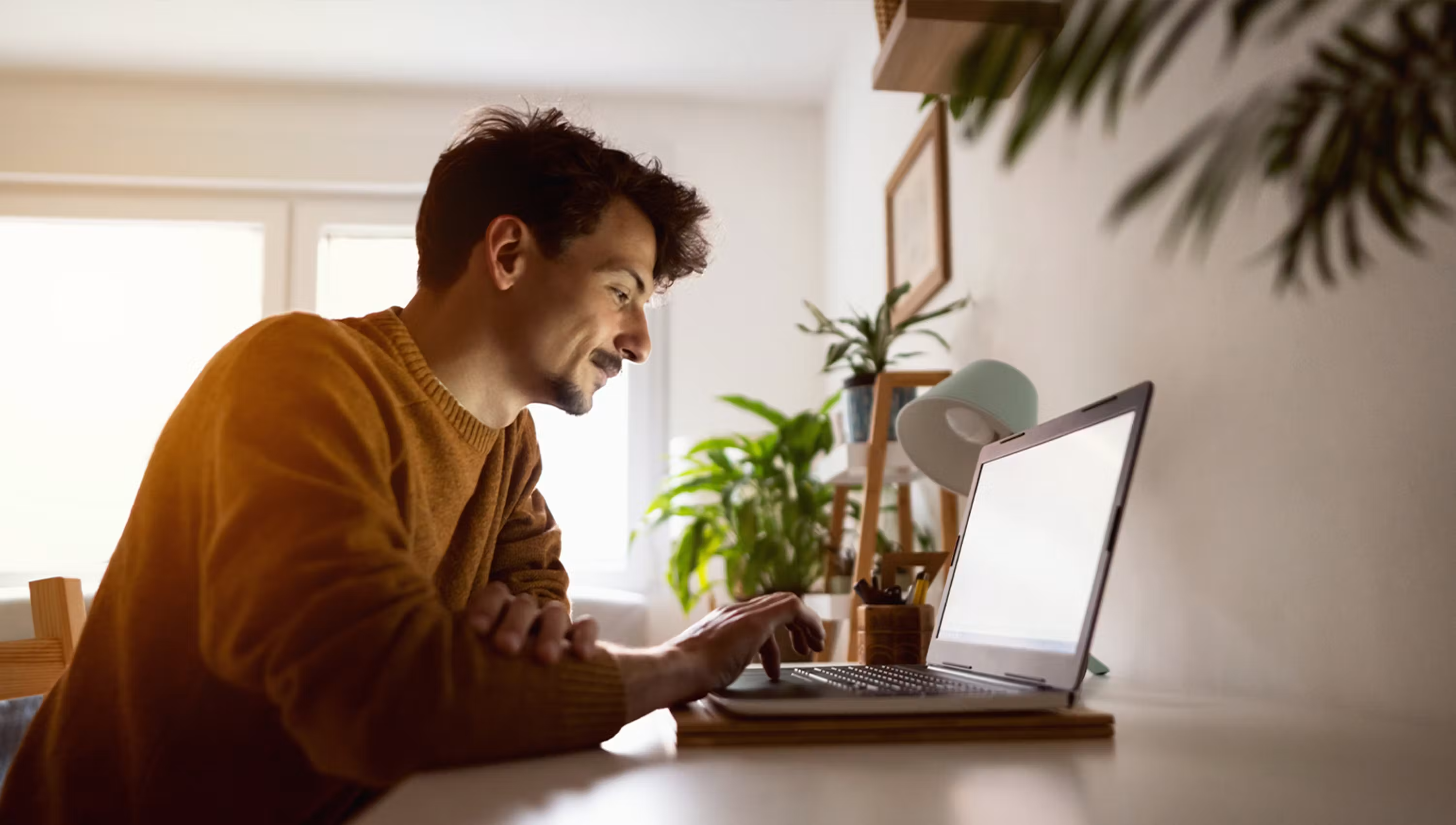 Man sitting down using laptop