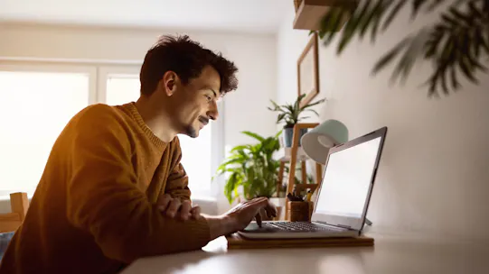 Man sitting down using laptop