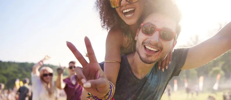 Two young people having fun at a festival