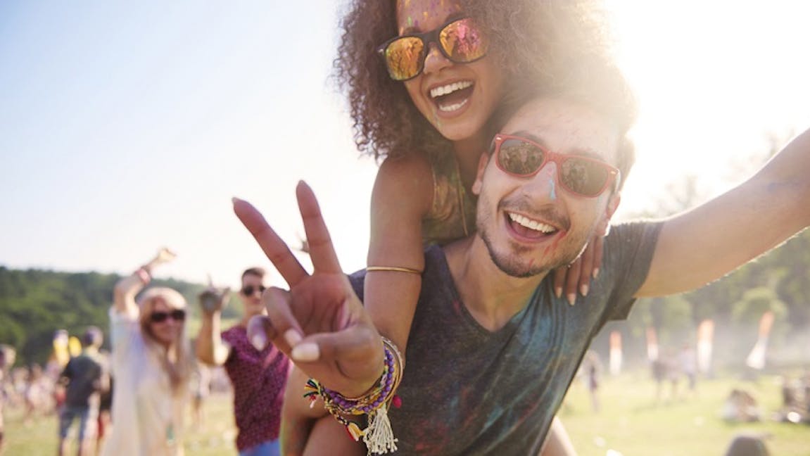 Two young people having fun at a festival
