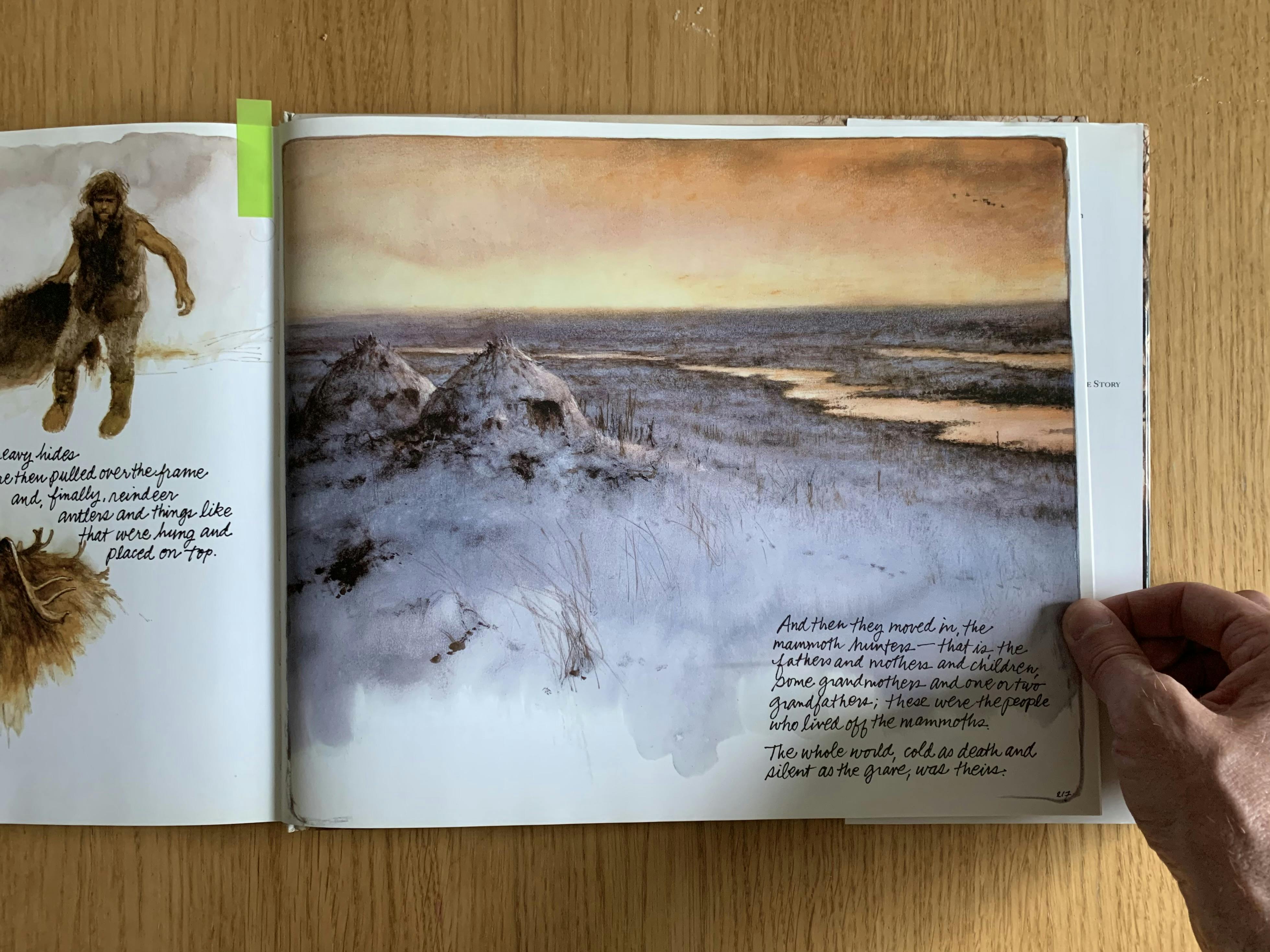 An inside spread of my copy of “Journey to the Ice Age” by Rien Poortvliet. An illustration depicts two ice-age shelters, covered in snow, beside a river at dusk.