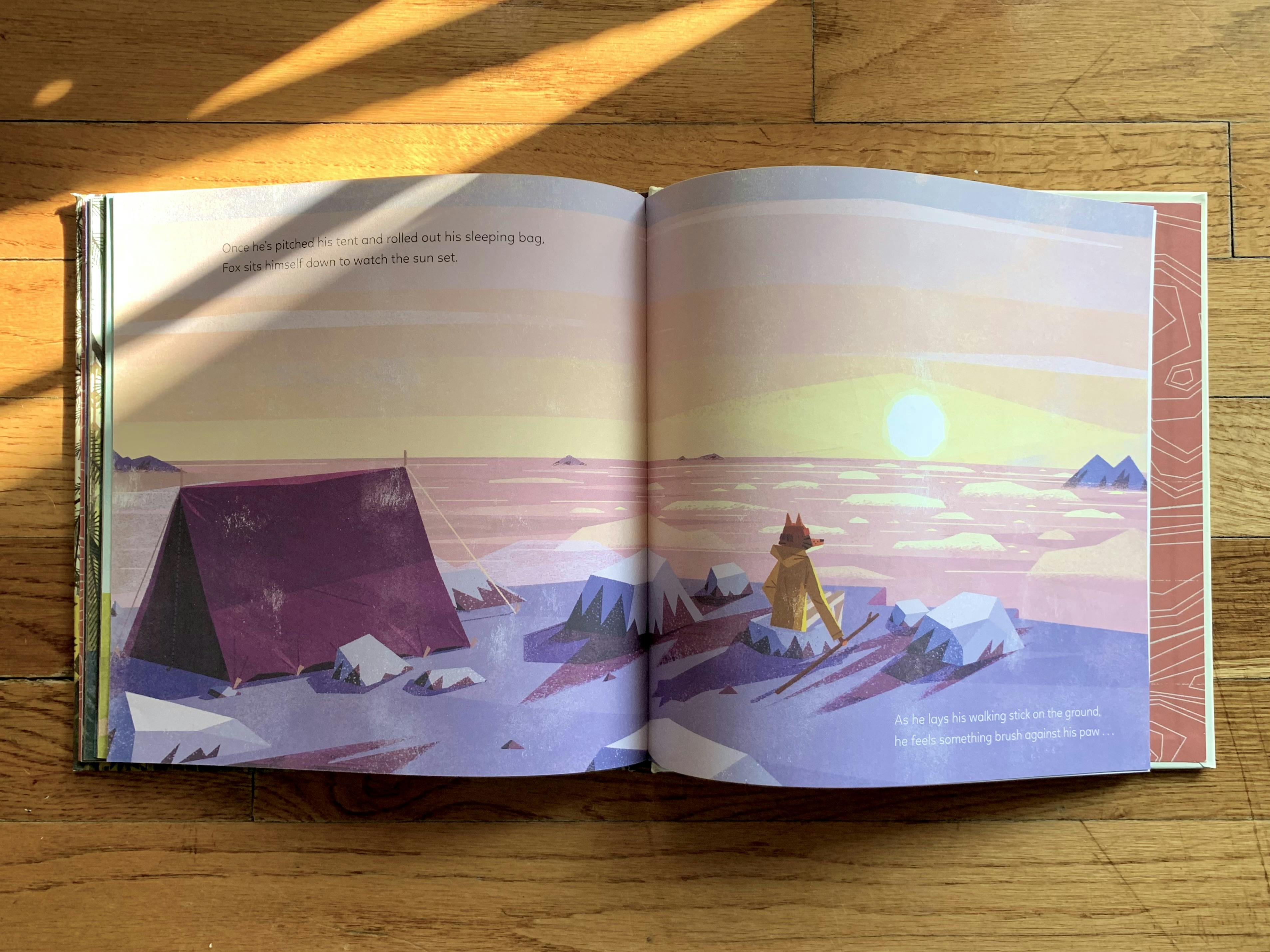 An inside spread of my copy of ‘The Golden Glow’. Fox sits on the peak of a mountain, watching the sun set. Peaks poke through the clouds in the distance.