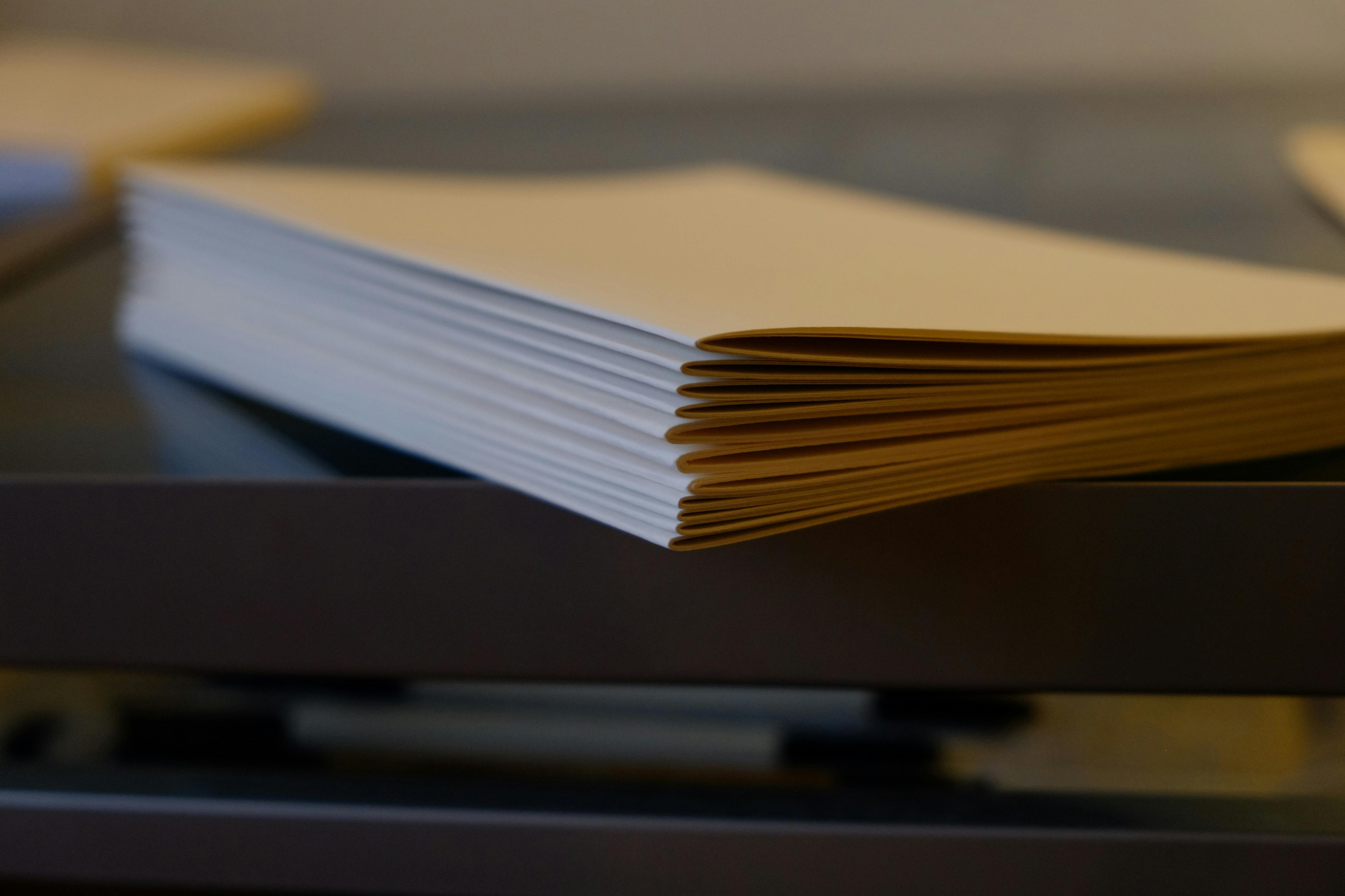 A stack of folded “signatures” for the paper block (pages) of Andy’s journal