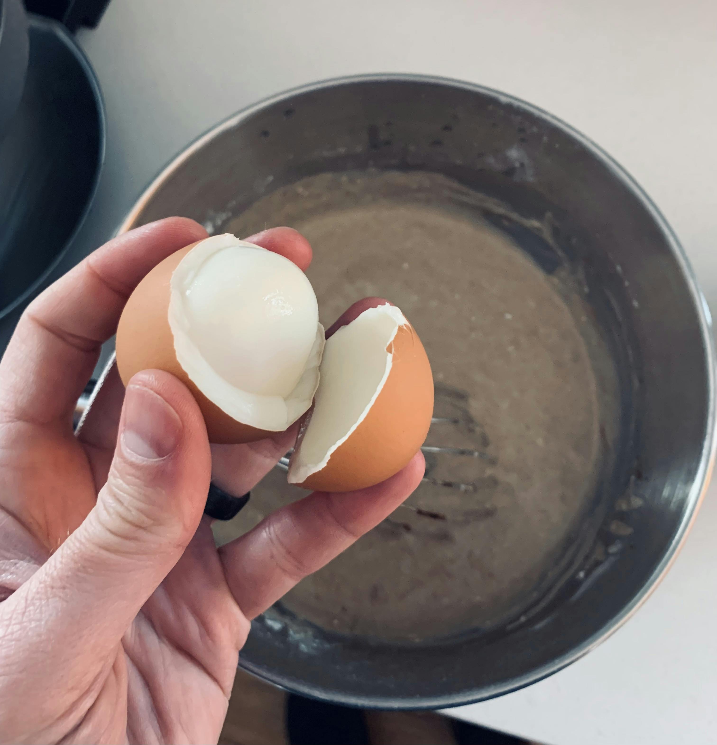 Cracking an egg over a bowl of waffle batter