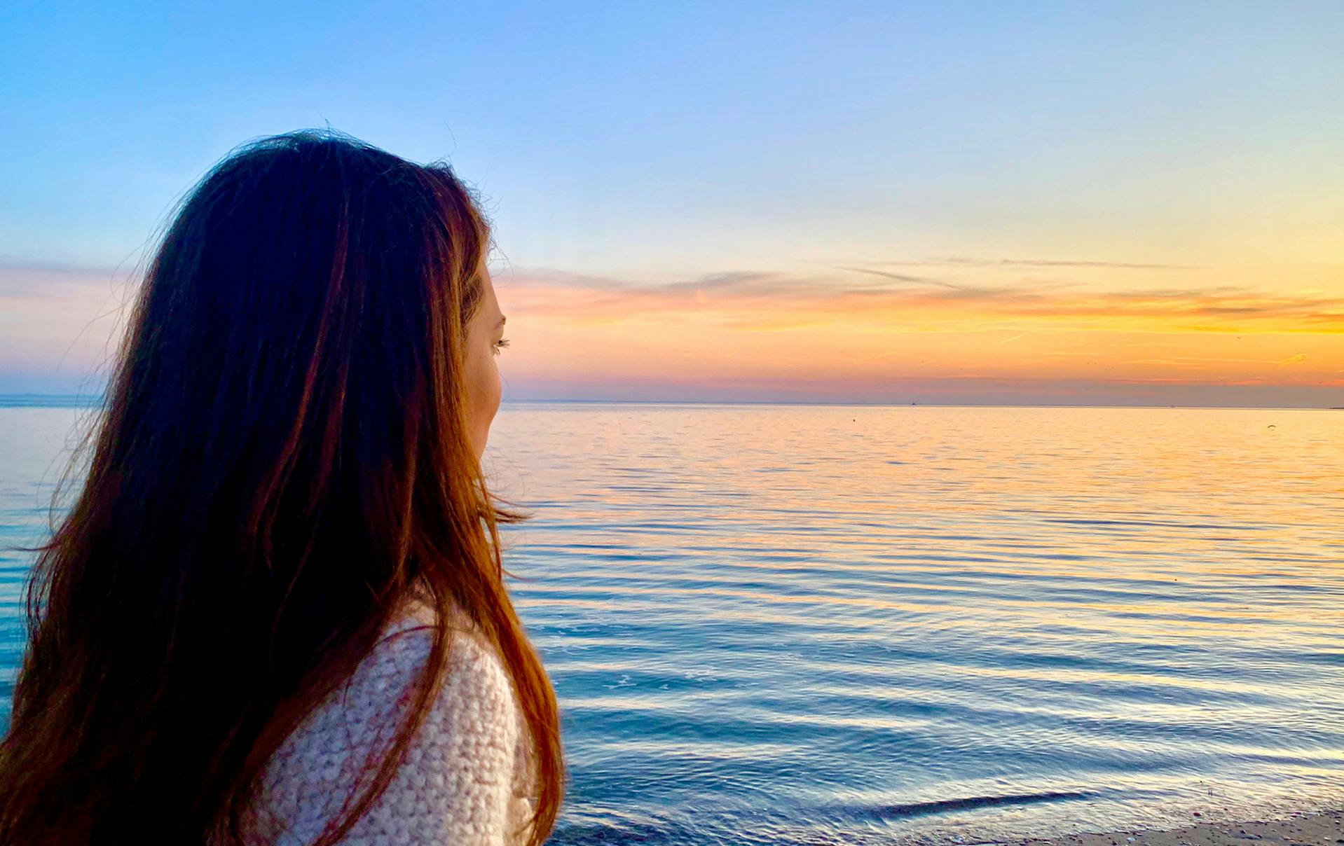 Julie looking at a beach sunset