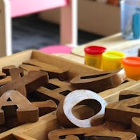 Buchstaben Holzblöcke und Knete auf einem Tisch