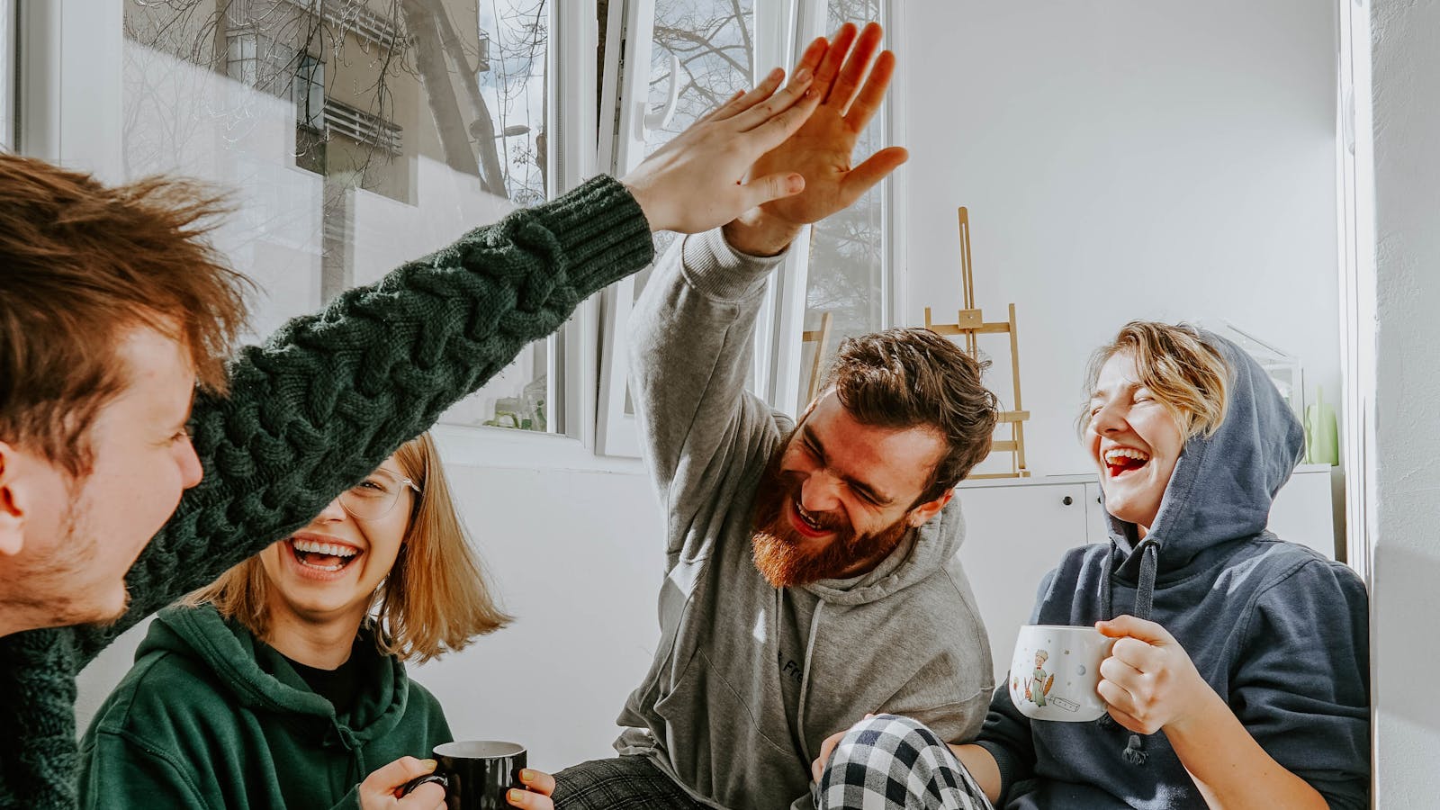 a group of people with 2 high-fiving