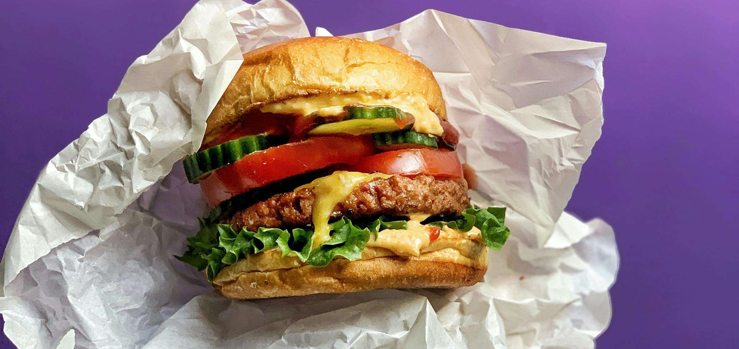 A hang holding a large Cheeseburger