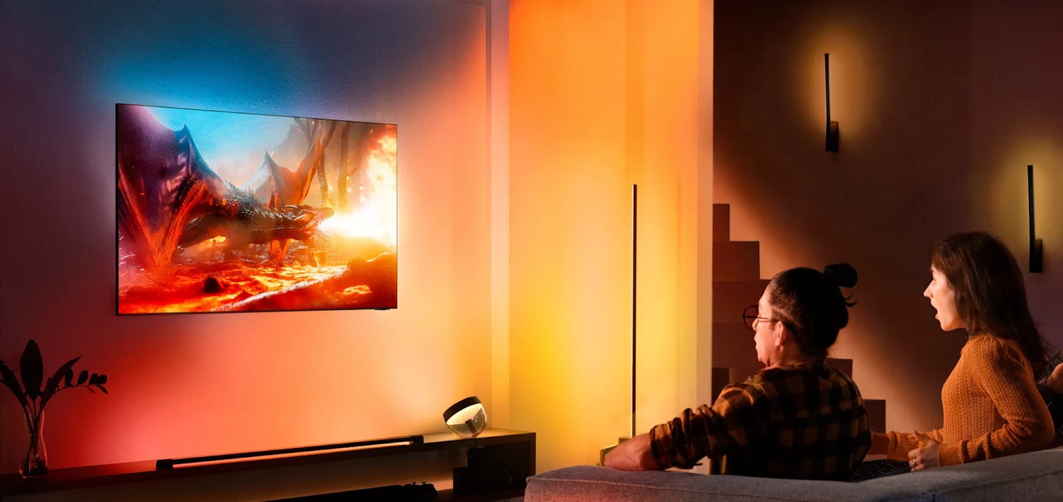 Two People sitting in front of a TV with a backlight