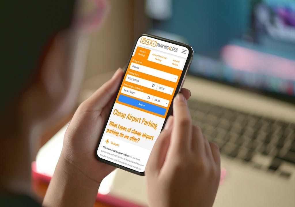 Person viewing Parking4less website on mobile phone