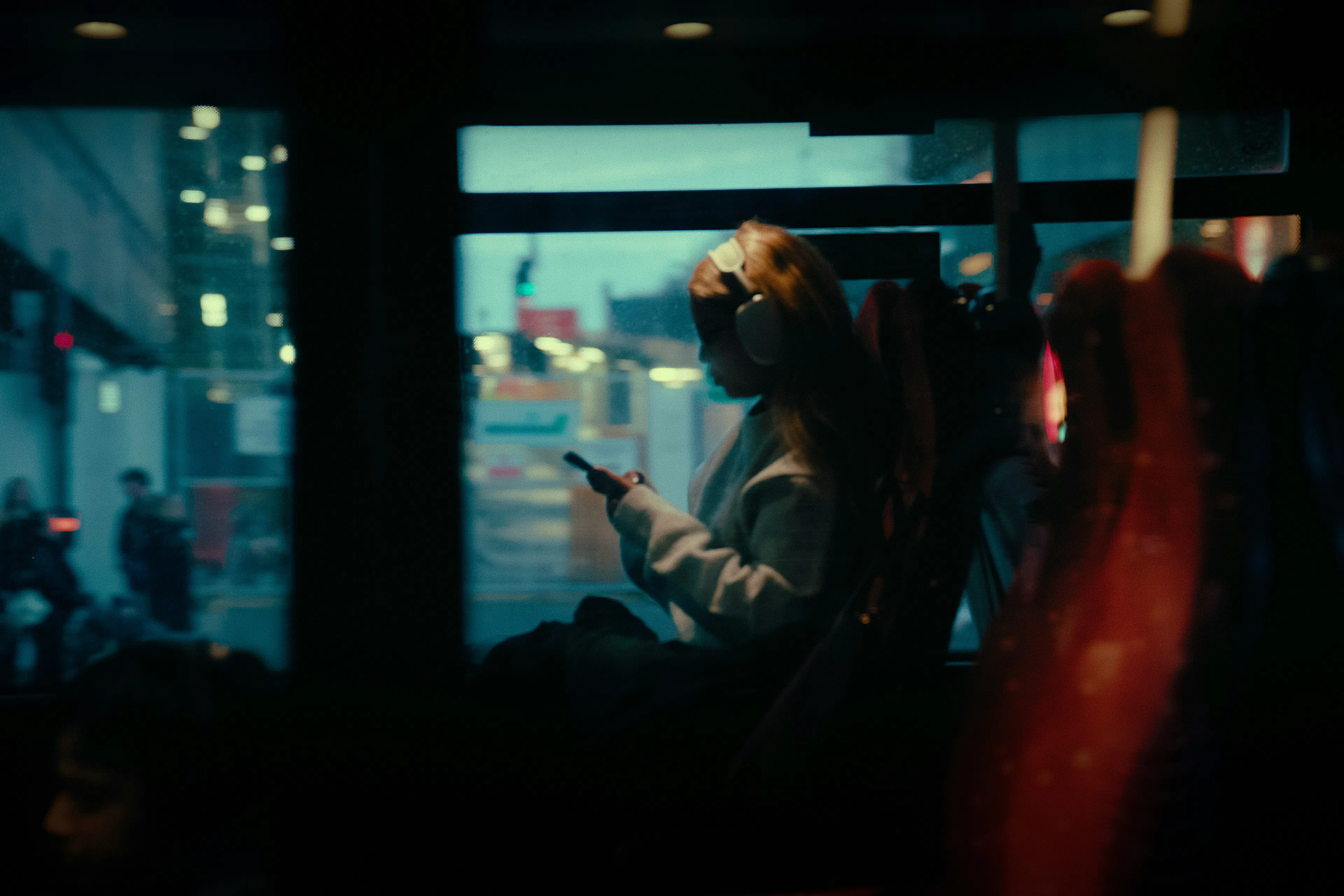 woman on bus looking at phone