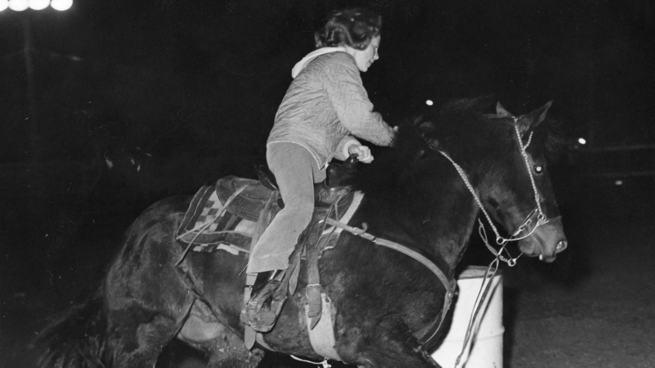 Reba barrel racing as a young child.