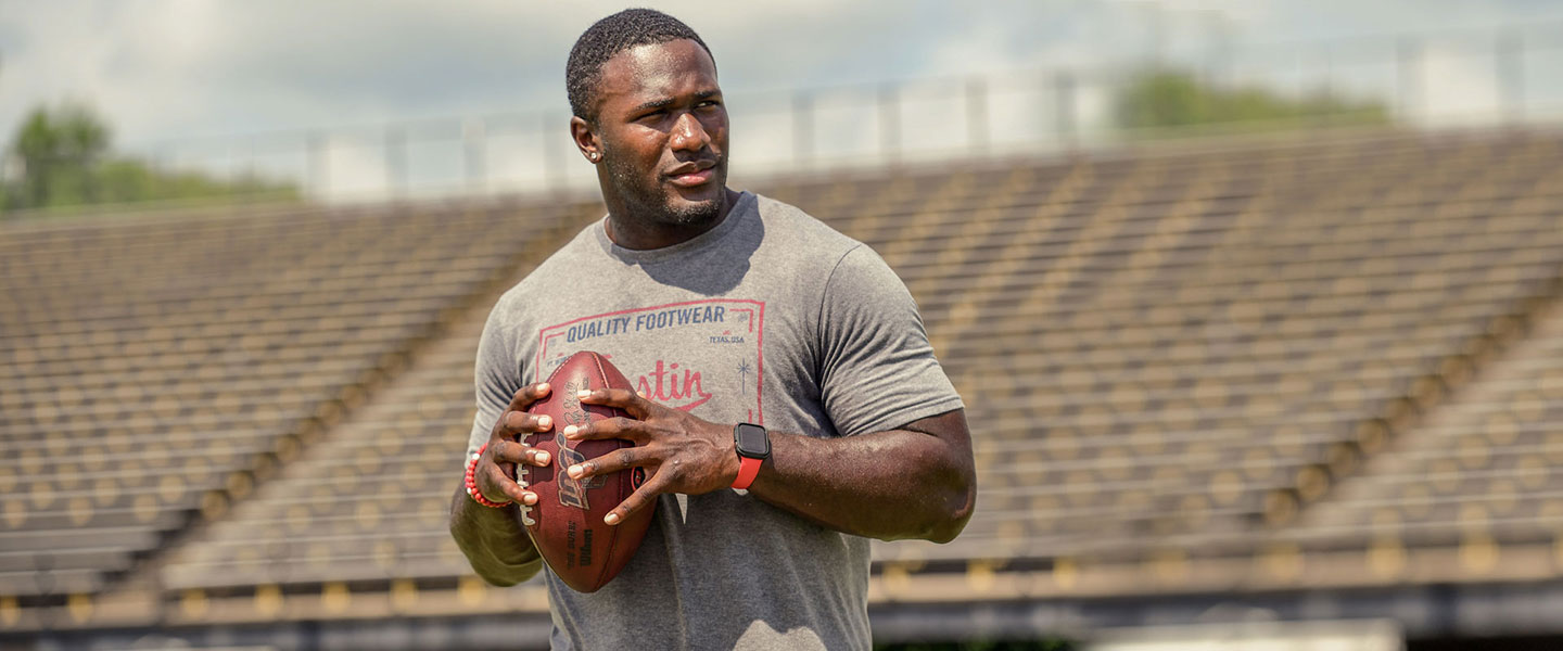 Devin White holding a football.