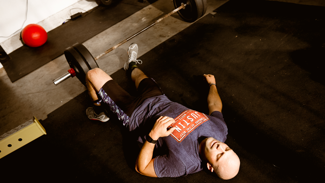 PRCA Bullfighter Dusty Tuckness laying on the floor recovering after a hard workout.