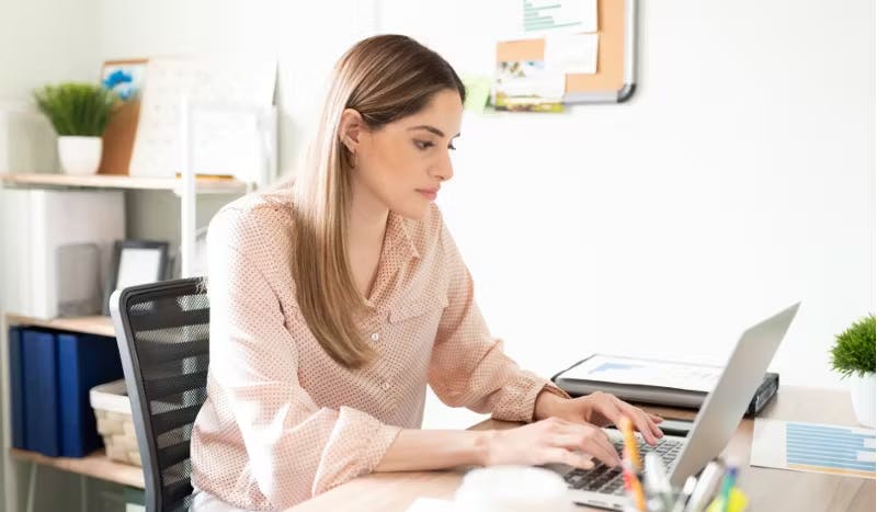 a woman working on her computer