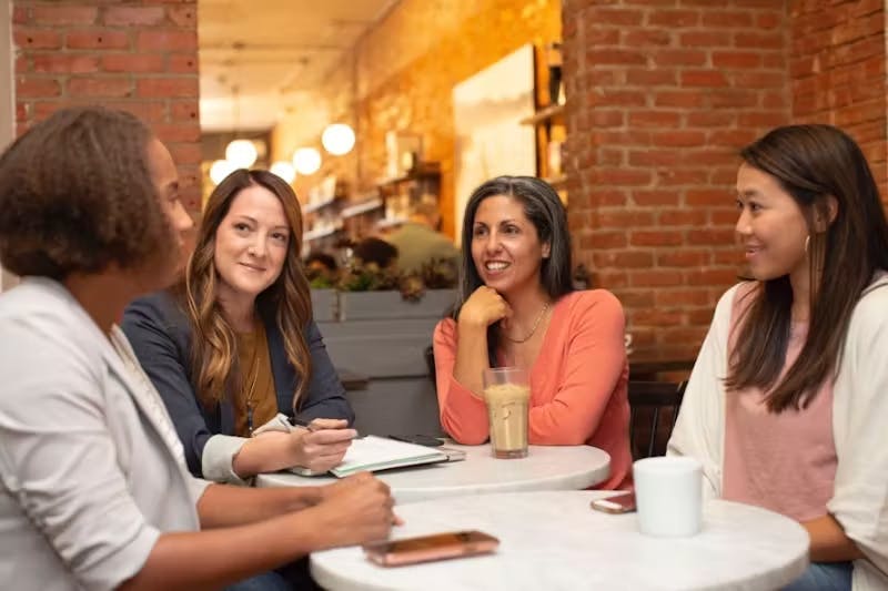 Business women sitting around a table