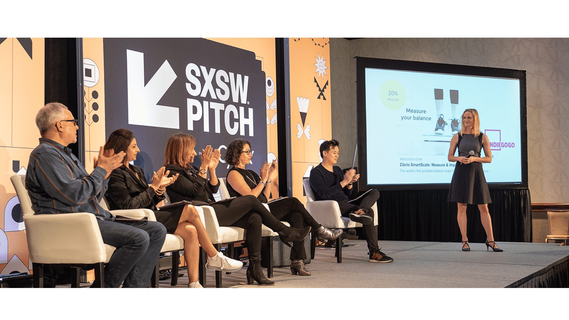 Startup pitch competition stage — founder presenting