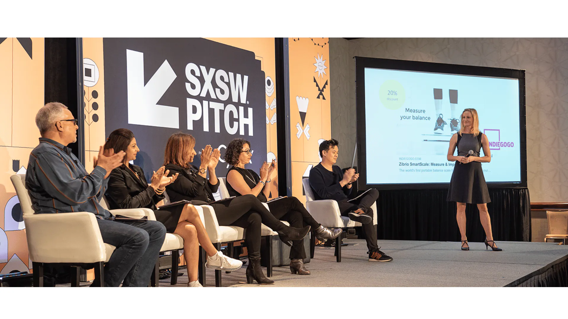 Startup pitch competition stage — founder presenting