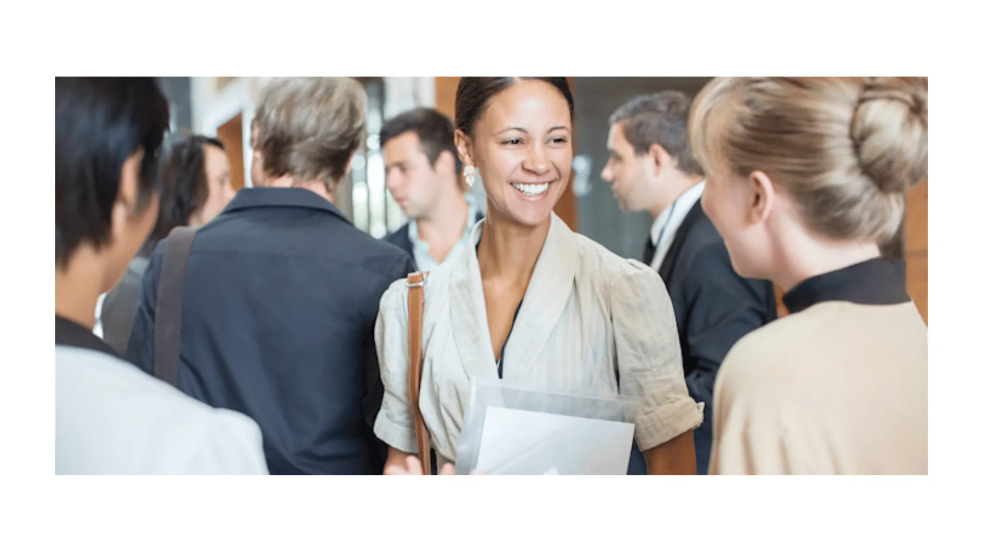 Professional at a networking event listening attentively to a conversation 