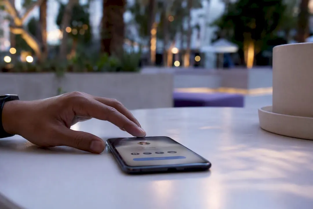 Finger tapping real estate listings link on phone