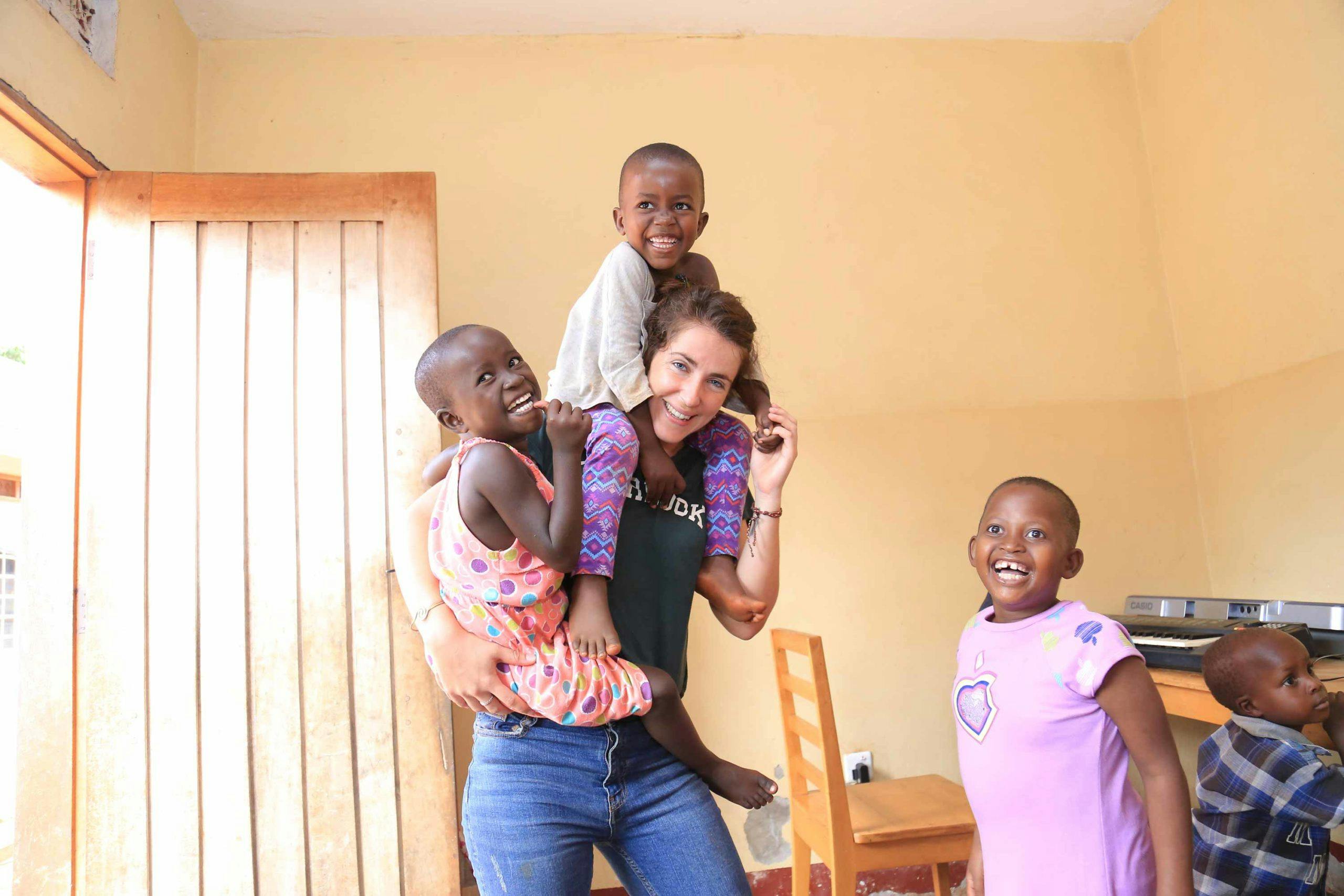 Volunteer playing with children at St. Francis health care services