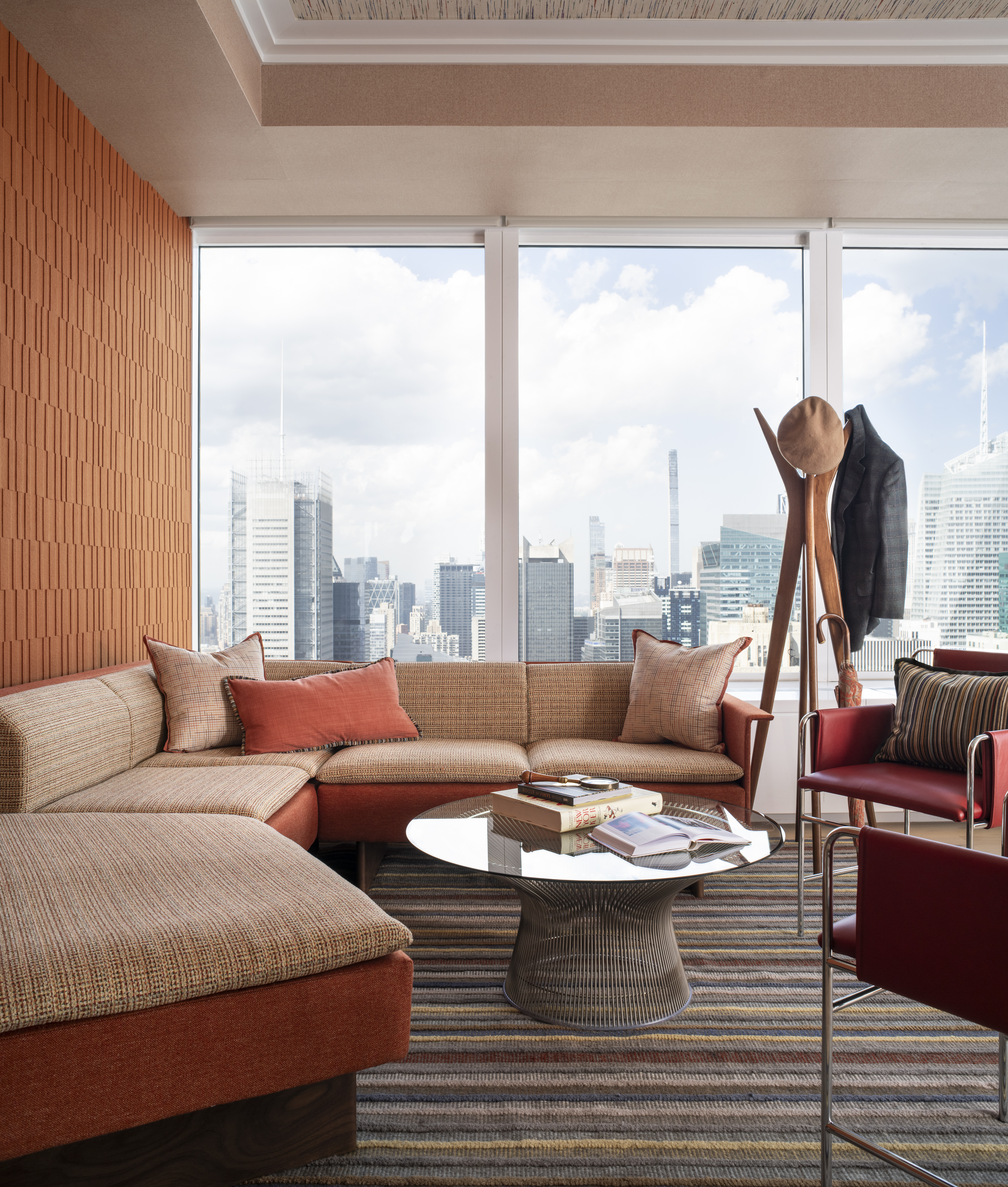 Luxury executive office lounge at One Penn Plaza designed by K.A. Murphy Interiors with custom furnishings, contemporary textiles, and panoramic New York City views.