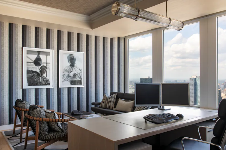 Luxury executive office at One Penn Plaza designed by K.A. Murphy Interiors with custom acoustic wall treatments, contemporary furnishings, and expansive New York City views.