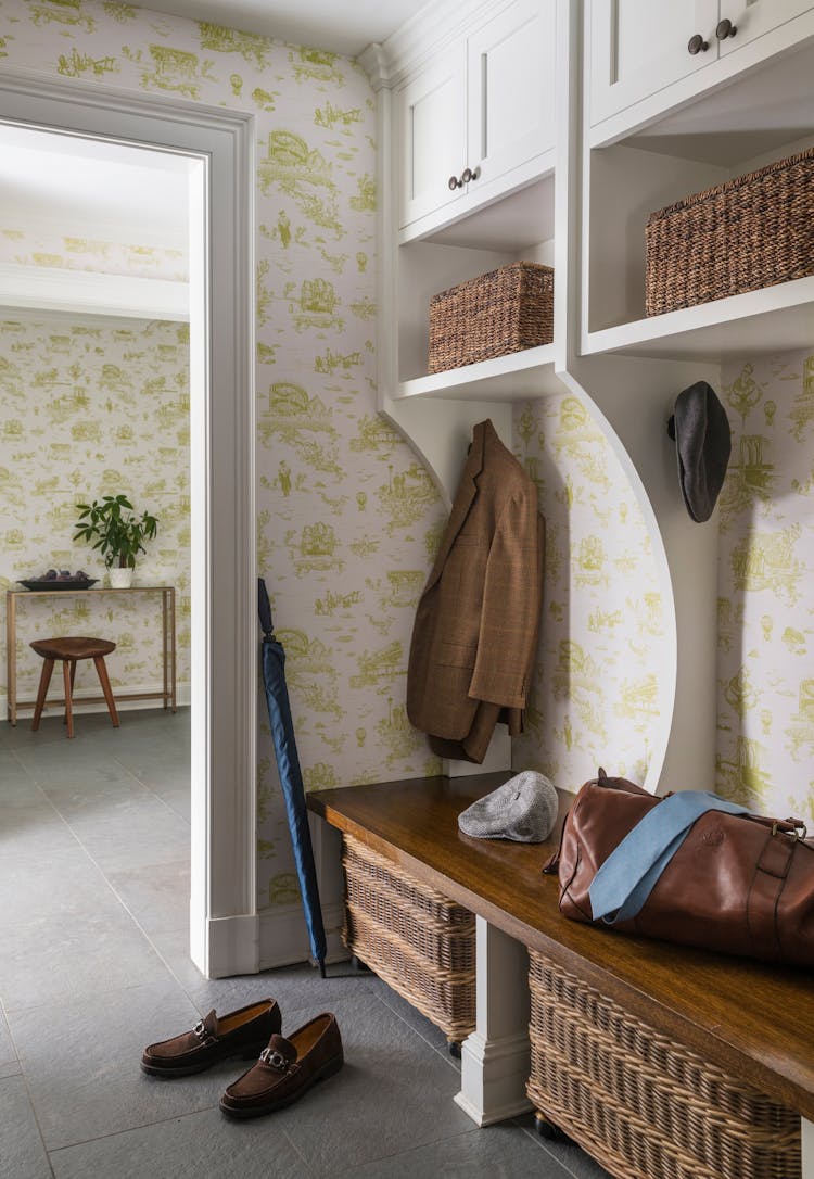 Functional and stylish mudroom in a Long Island Colonial Revival home featuring built-in storage, bench seating, and classic design details, designed by K.A. Murphy Interiors.