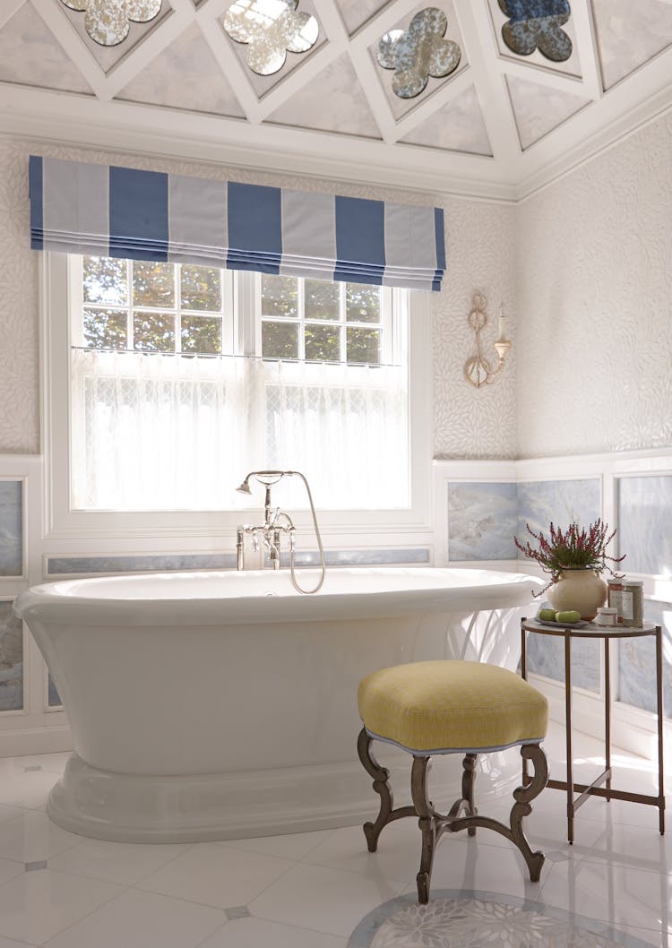 Elegant soaking tub in the master bathroom of a Long Island Colonial Revival home, offering a serene retreat, by K.A. Murphy Interiors