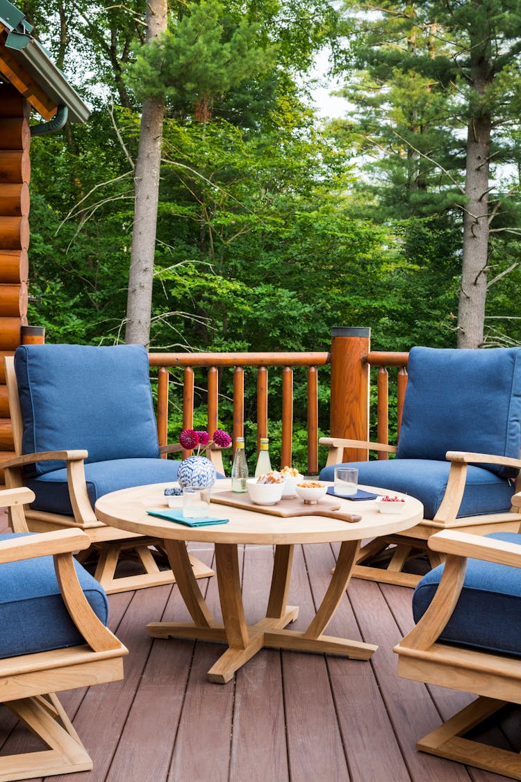 Inviting outdoor seating area in a Hudson Valley log cabin with comfortable furnishings and natural surroundings, designed by K.A. Murphy Interiors
