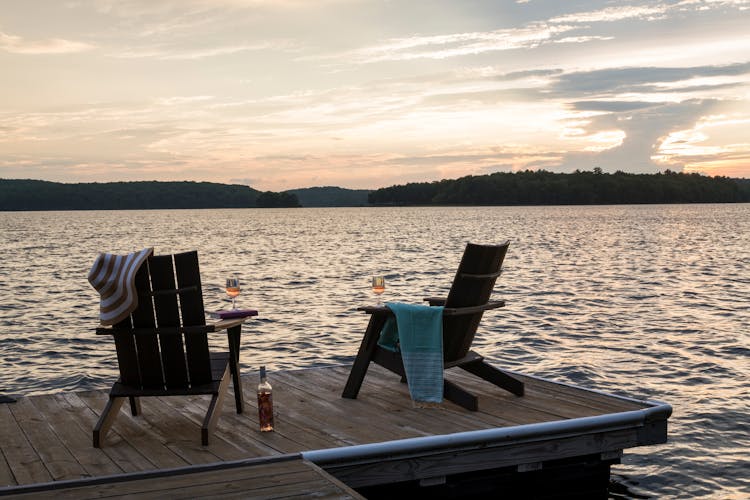 Scenic pier at sunset near a Hudson Valley log cabin, offering tranquil views and natural beauty, designed by K.A. Murphy Interiors