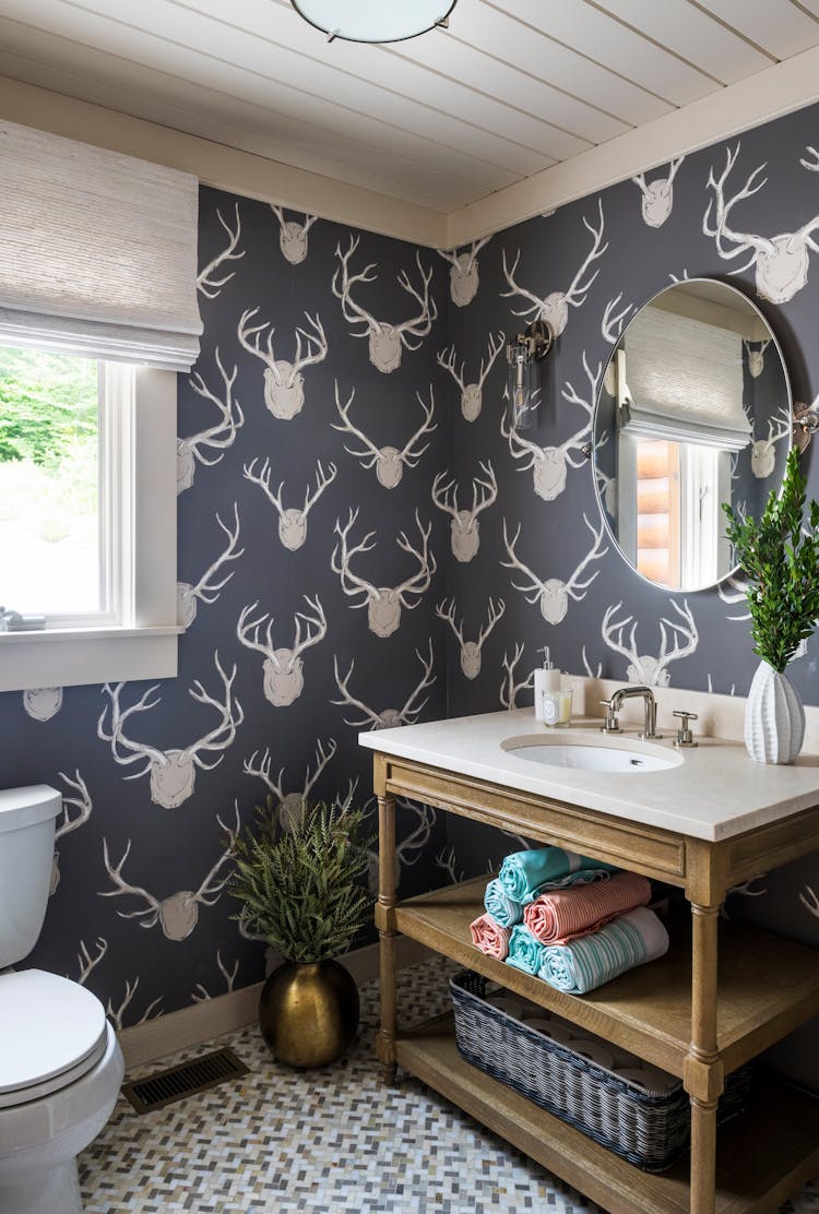 Chic powder room in a Hudson Valley log cabin with rustic finishes and modern fixtures, designed by K.A. Murphy Interiors