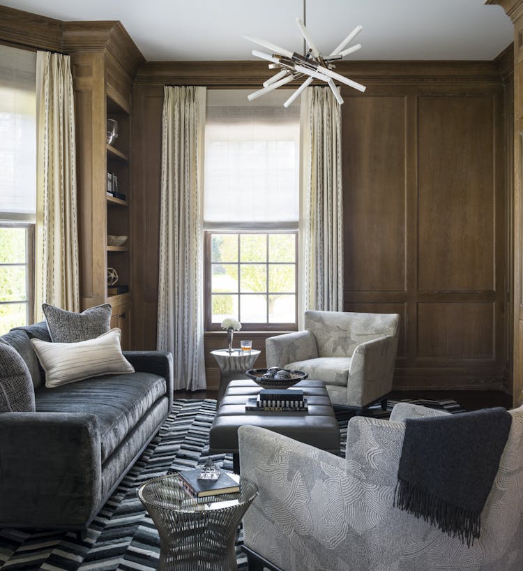 Elegant office space in a Manhattan study featuring a black-and-white color palette, velvet sofa, and cowhide rug, designed by K.A. Murphy Interiors